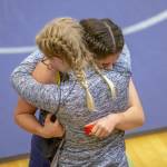 Two wrestlers embrace after a loss during a wrestling scramble at Everett High School on Wednesday, Dec. 13, 2023 in Everett, Washington. (Olivia Vanni / The Herald)