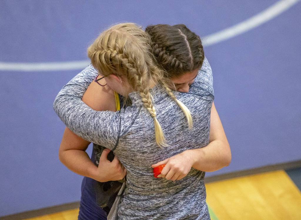 Two wrestlers embrace after a loss during a wrestling scramble at Everett High School on Wednesday, Dec. 13, 2023 in Everett, Washington. (Olivia Vanni / The Herald)