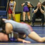 A Kamiak coach yell instructions to her wrestler on Wednesday, Dec. 13, 2023 in Everett, Washington. (Olivia Vanni / The Herald)