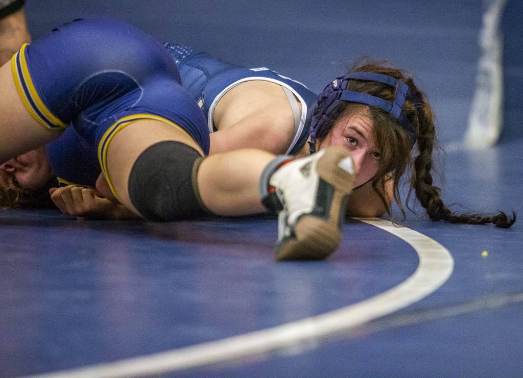 Arlingtons Danielle Crew looks forward while trying to pin her opponent on Wednesday, Dec. 13, 2023 in Everett, Washington. (Olivia Vanni / The Herald)