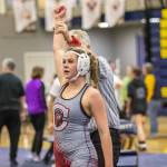 A Cascade wrestler has her arm raised after beat her opponent on Wednesday, Dec. 13, 2023 in Everett, Washington. (Olivia Vanni / The Herald)