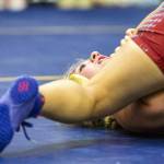 A wrestler takes a deep breath before being pinned by their opponent on Wednesday, Dec. 13, 2023 in Everett, Washington. (Olivia Vanni / The Herald)