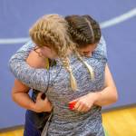 Two wrestlers embrace after a loss during a wrestling scramble at Everett High School on Wednesday, Dec. 13, 2023 in Everett, Washington. (Olivia Vanni / The Herald)