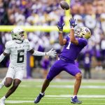 Washington wide receiver Rome Odunze (1) makes a catch in front of Oregon defensive back Jahlil Florence (6) during the first half of an NCAA college football game, Saturday, Oct. 14, 2023, in Seattle. (AP Photo/Lindsey Wasson)