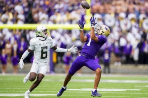 Washington wide receiver Rome Odunze (1) makes a catch in front of Oregon defensive back Jahlil Florence (6) during the first half of an NCAA college football game, Saturday, Oct. 14, 2023, in Seattle. (AP Photo/Lindsey Wasson)