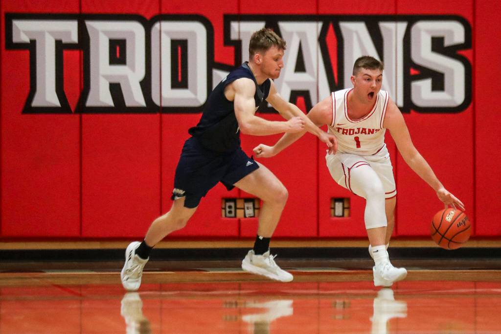 Everett Community Colleges Ethan Martin (1) moves with the ball during a game against Tacoma on Dec. 9 at Everett Community College in Everett. Martin, a former Arlington High School star, now plays his home games on a court named for his grandfather, former longtime Trojans mens basketball coach Larry Walker. (Annie Barker / The Herald)