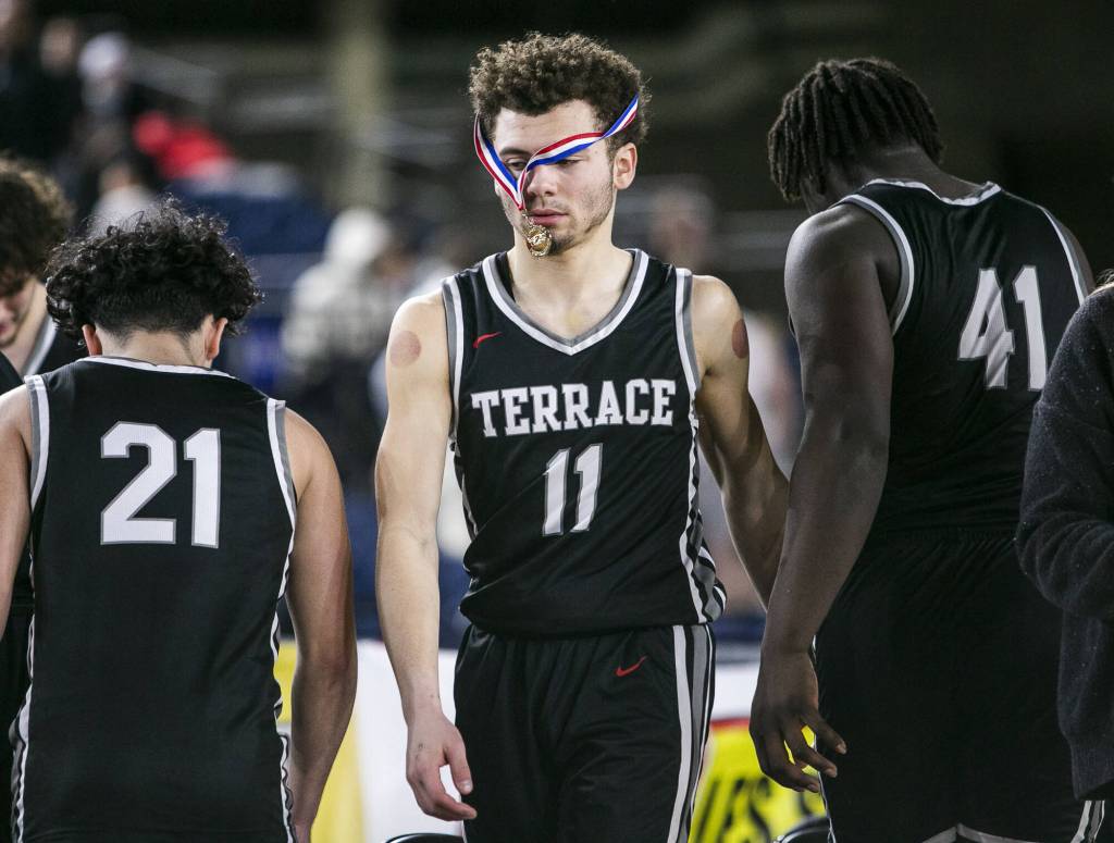 Mountlake Terraces Chris Meegans sportsmanship medal hangs over his face as his team packs up after losing to ODea in the 3A quarterfinal game on Thursday, March 2, 2023, in Tacoma, Washington. (Olivia Vanni / The Herald)