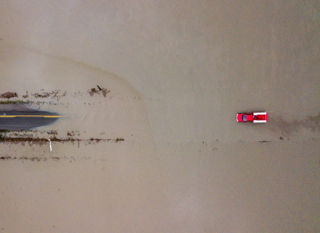 Olivia Vanni / The Herald
In one of the most memorable images captured by Daily Herald photographers in 2023, a red truck navigates through floodwaters covering 28th Avenue NW along Pioneer Highway on Dec. 6 in Stanwood. See more Photos of the Year on Pages A4 and A5.