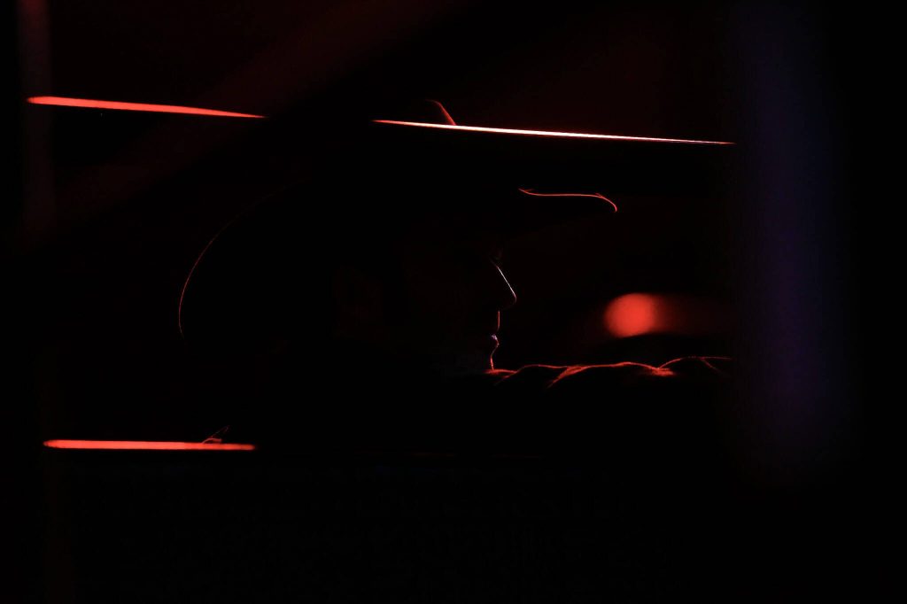 A man wearing a cowboy hat looks out into the arena during PBR: Unleash The Beast at Angel of the Winds Arena on Thursday, April 20, 2023, in Everett. (Annie Barker / The Herald)