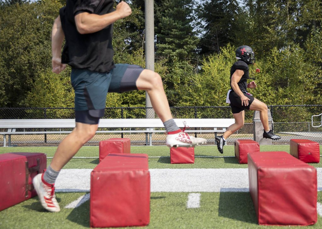 Archbishop Murphy football players run through warmups during practice on Aug. 24, 2023 in Everett, Washington. The new-look Wildcats are looking to embrace a youth movement under new head coach Joe Cronin after a winless season last fall. (Olivia Vanni / The Herald)