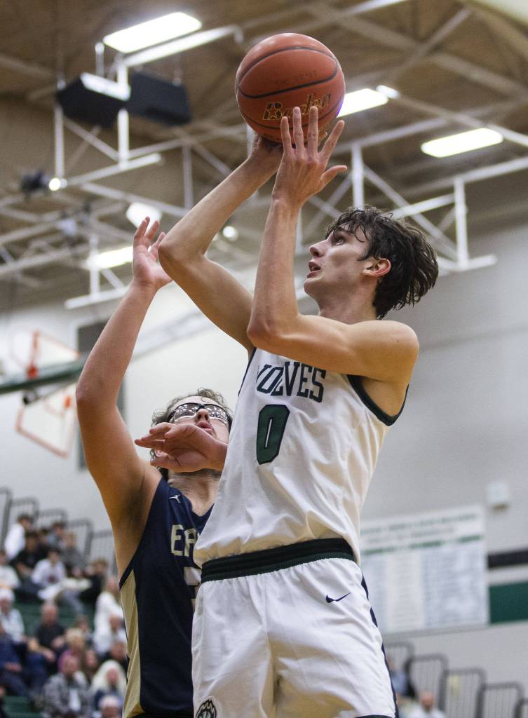 Jacksons Ryan McFerran jumps to make a layup during the game against Arlington on Nov in Everett. (Olivia Vanni / The Herald)