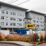 Storage containers and a dumpster sit in the parking lot outside of Claire’s Place on Monday, Dec. 4, 2023 in Everett, Washington. (Olivia Vanni / The Herald)