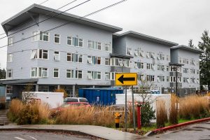 Storage containers and a dumpster sit in the parking lot outside of Claire’s Place on Monday, Dec. 4, 2023 in Everett, Washington. (Olivia Vanni / The Herald)