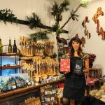 Juliana Uluave-Gould, owner of PNW Vibes, holds Coupeville Coffee Roasters Rustic Pacific Northwest Blend while surrounded by the art provided by her OVERSET FOLLOWS:store. (Photo by Luisa Loi)