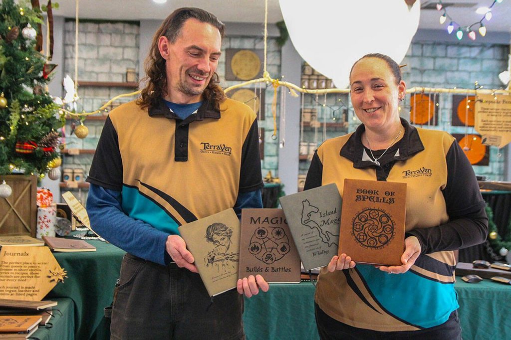 TerraVen owners Shea Looijen and Kristi Uhles hold some of the leather notebooks they designed. (Photo by Luisa Loi)