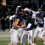 Arlington players celebrate Chase Deberrys first-quarter touchdown against Ridgeline during a playoff matchup Nov. 10, 2023, at Arlington High School in Arlington. (Ryan Berry / The Herald)