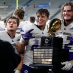 Lake Stevens players take photos with the championship trophy after their win over Graham-Kapowsin during the WIAA 4A Football State Championship on Saturday, Dec. 2, 2023, at Husky Stadium in Seattle, Washington. (Ryan Berry / The Herald)