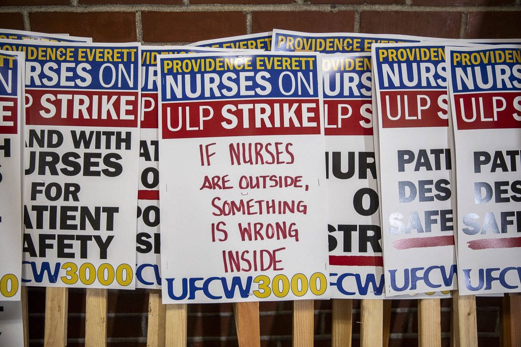 Strike signs are displayed during a press confrence for the Providence nurses who gave a 10-day strike notice two days ago at the Everett Labor Temple in Everett, Washington on Monday, Nov. 6, 2023. (Annie Barker / The Herald)