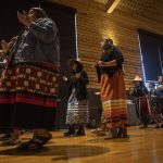 A welcome song is played and sang by Tulalip performers during a Road to Healing event at the Tulalip Gathering Hall in Marysville, Washington on Sunday, April 23, 2023. The tour is lead by United States Secretary of the Interior Deb Haaland and Department of the Interior Assistant Secretary Bryan Newland. (Annie Barker / The Herald)
