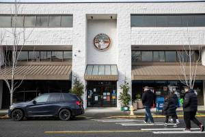 Pedestrians cross the street in front of Edmonds City Hall on Thursday, Dec. 28, 2023 in Edmonds, Washington. (Olivia Vanni / The Herald)