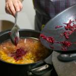 Cook Ivanna Tomashevska adds shredded beets to finish off a batch of borscht at European Deli Svitlana. (Ryan Berry / The Herald)