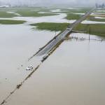A car sits abandoned surrounded by floodwater along 28th Avenue NW on Wednesday, Dec. 6, 2023 in Stanwood, Washington. (Olivia Vanni / The Herald)