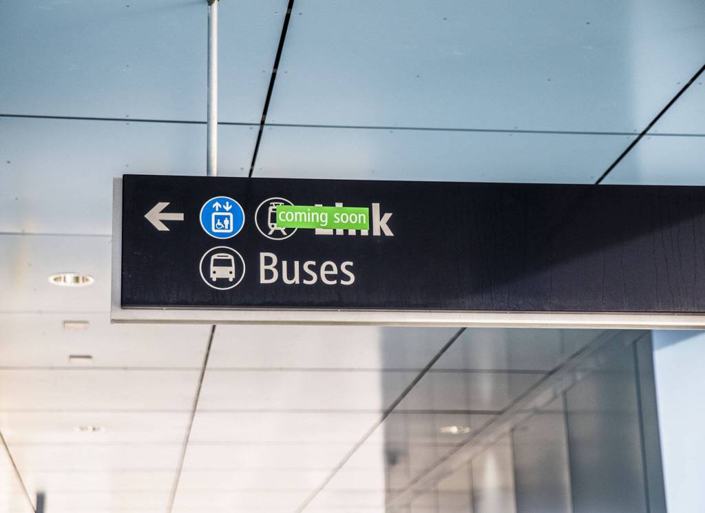A sign directing people to Sound Transits Link Lynnwood City Center Station is covered by a coming soon sticker on Thursday, Dec. 28, 2023 in Lynnwood, Washington. (Olivia Vanni / The Herald)
