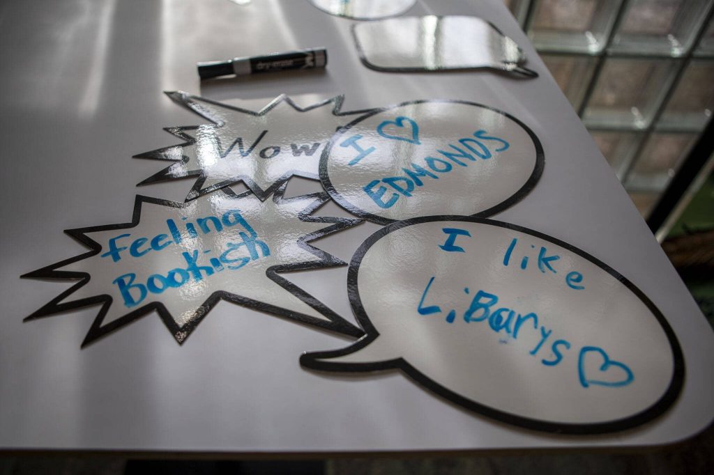 Notes on white boards for photos sit available during the grand reopening of the Edmonds Library in Edmonds, Washington on Saturday, Jan. 13, 2024. (Annie Barker / The Herald)