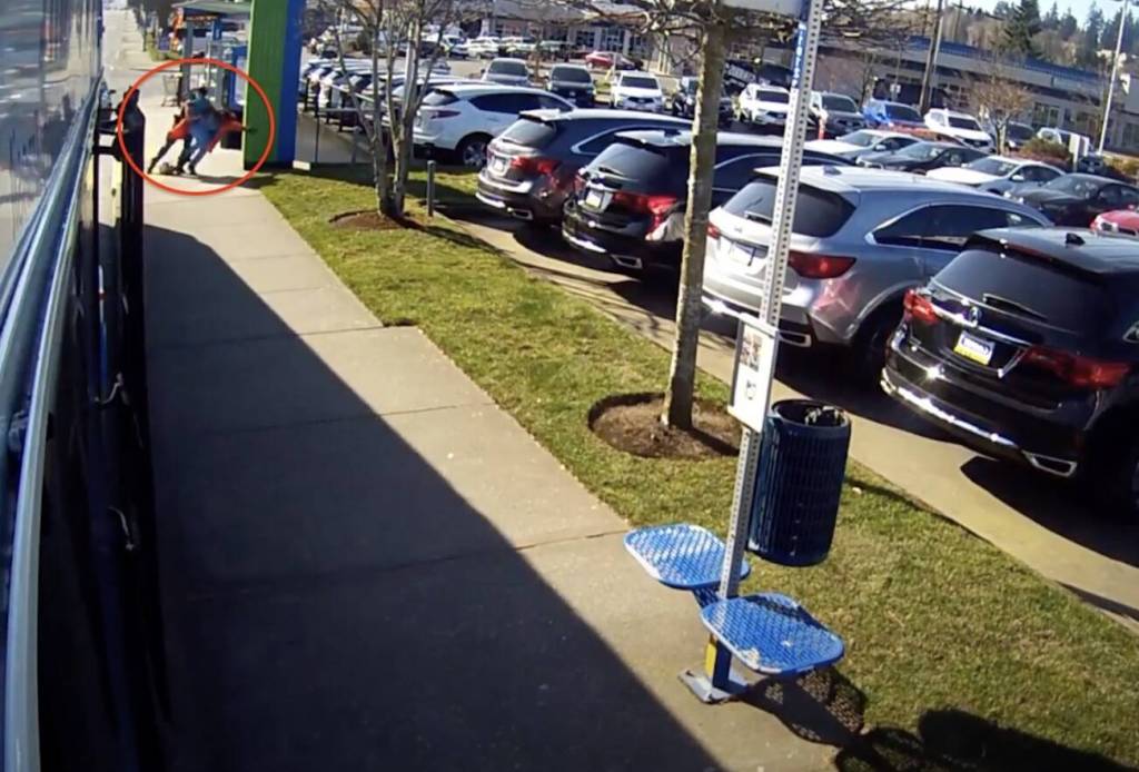 Surveillance footage shows sheriff’s deputy Matt Lease tackling Sharron Wilson to the ground at the bus stop in Edmonds on March 21, 2020.
