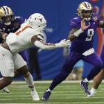 Washington quarterback Michael Penix Jr. (9) scrambles with the ball against Texas during the second half of the Sugar Bowl on Monday in New Orleans. (AP Photo/Gerald Herbert)
