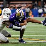 Texas defensive back Terrance Brooks (8) hits Washington wide receiver Rome Odunze (1) during the second half of the Sugar Bowl CFP NCAA semifinal college football game, Monday, Jan. 1, 2024, in New Orleans. Brooks received a interference penalty on the play. (AP Photo/Gerald Herbert)