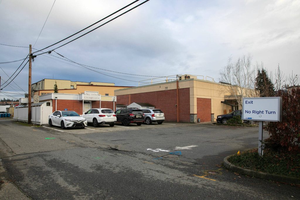 The lot behind the old Sky Valley Chiropractic Clinic and Union Bank is used for parking Wednesday, Jan. 3, 2024, in downtown Monroe, Washington. (Ryan Berry / The Herald)