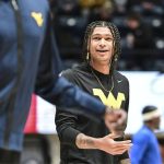 West Virginia Guard RaeQuan Battle looks on prior to the game against the Pittsburgh Panthers on Dec. 6, 2023, in Morgantown, WV. Battle, formerly of Montana State, has yet to play this season. College athletes like Battle who were denied the chance to play immediately after transferring a second time can return to competition, for now, after a federal judge issued a 14-day temporary restraining order Wednesday, Dec. 13, 2023, against the NCAA. (William Wotring/The Dominion-Post via AP)