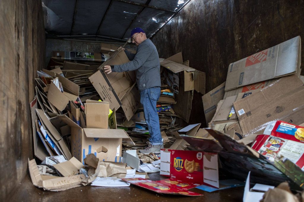 Gordon Sparks stacks cardboard during a recycling event at 1049 State Ave in Marysville, Washington on Saturday, Jan. 6, 2024. (Annie Barker / The Herald)