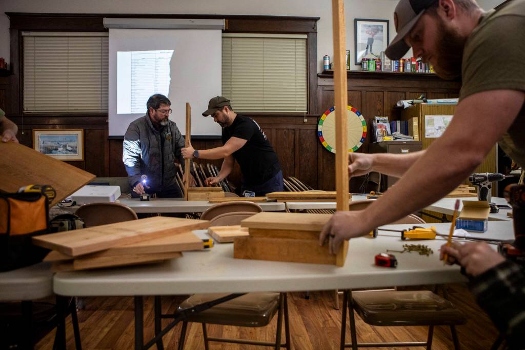 Tom Elliott, left, and Ken Smith, right, build duck boxes along with other members of the Washington Waterfowl Association during a meeting at the Twin Cities Sportsmens Club in Stanwood, Washington on Wednesday, Jan. 10, 2024. (Annie Barker / The Herald)
