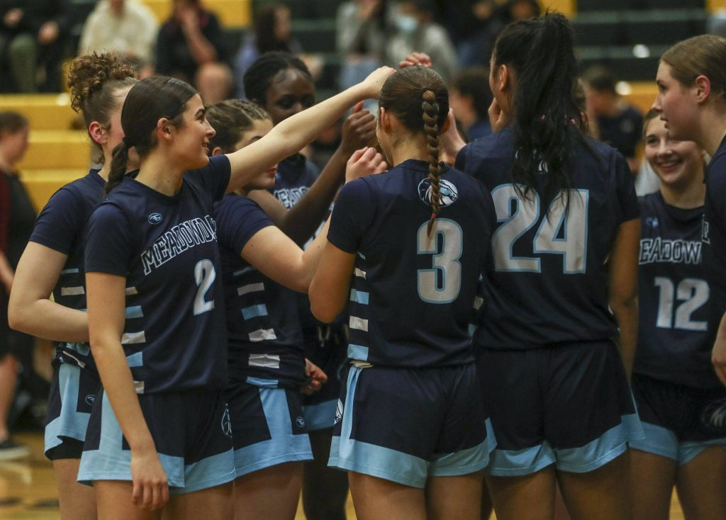 Meadowdales Gia Powell (2) huddles with her team during a game against Shorecrest on Jan. 5 at Shorecrest High School in Shoreline. (Annie Barker / The Herald)