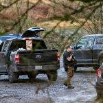 A large number off law enforcement are gathered at a Skykomish River water access on Ben Howard Road on Wednesday, Jan. 3, 2024, in Monroe, Washington. (Ryan Berry / The Herald)
