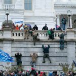 Violent insurrectionists loyal to President Donald Trump scale the west wall of the the U.S. Capitol in Washington, D.C on Jan. 6, 2021. (AP Photo/Jose Luis Magana, File)