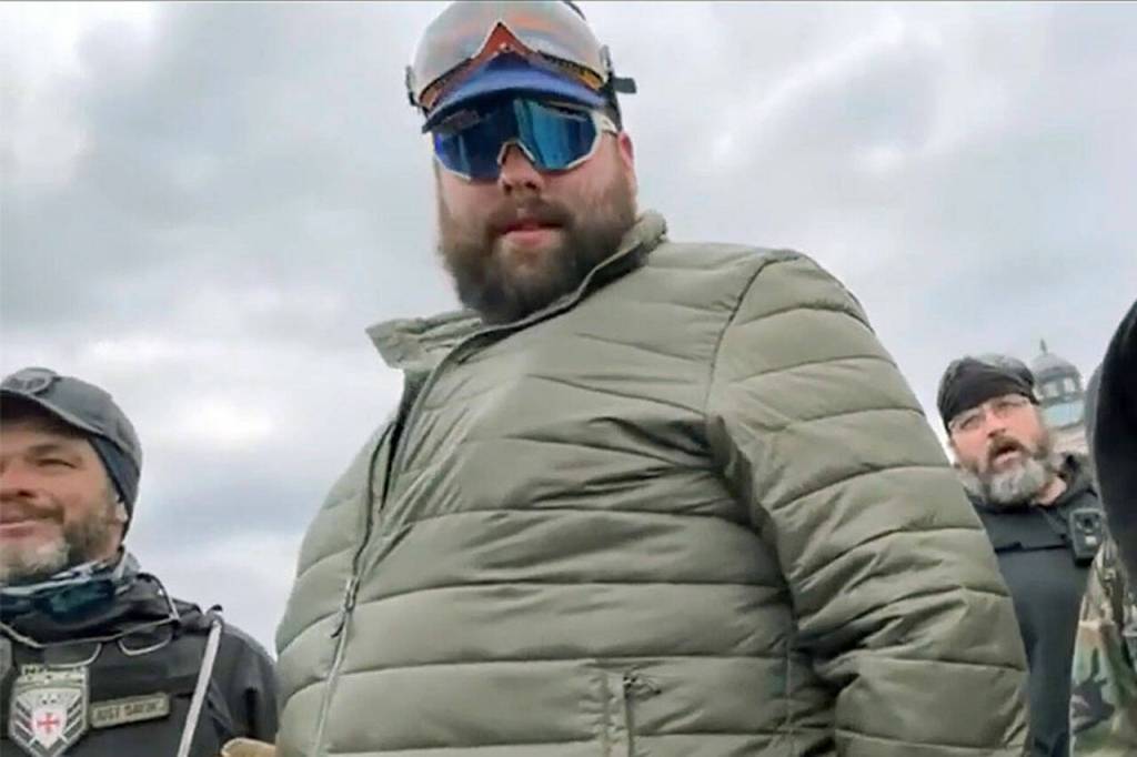 Daniel Scott (center, in green jacket) is shown in a video before the Proud Boys and other rioters stormed the U.S. Capitol building on Jan. 6, 2021, in Washington, D.C. (U.S. Attorneys Office for the District of Columbia)