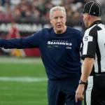Seattle Seahawks head coach Pete Carroll argues a call with side judge Jim Quirk (5) in the first half of an NFL football game against the Arizona Cardinals Sunday, Jan. 7, 2024, in Glendale, Ariz. (AP Photo/Rick Scuteri)