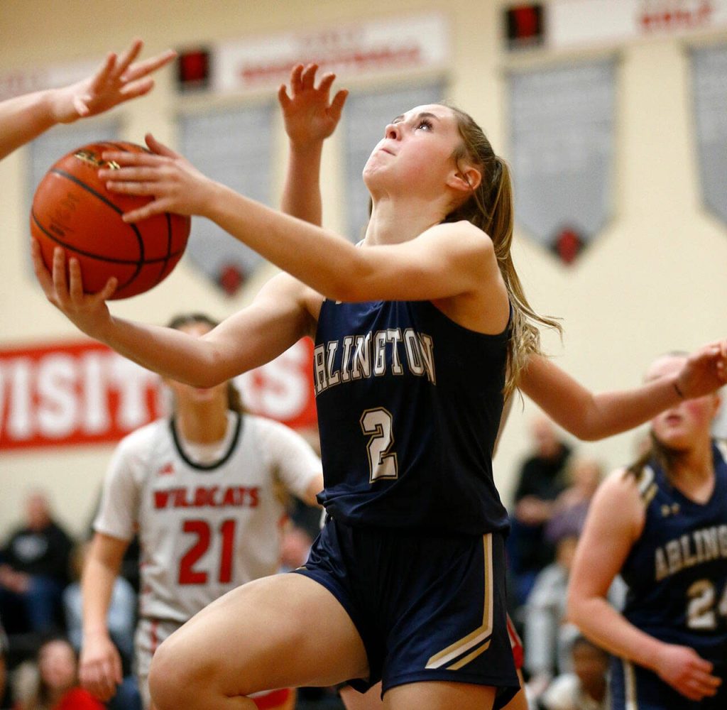 Arlington freshman Kailee Anderson tries for a layup against Archbishop Murphy on Tuesday, Jan. 9, 2024, at Archbishop Murphy High School in Everett, Washington. (Ryan Berry / The Herald)