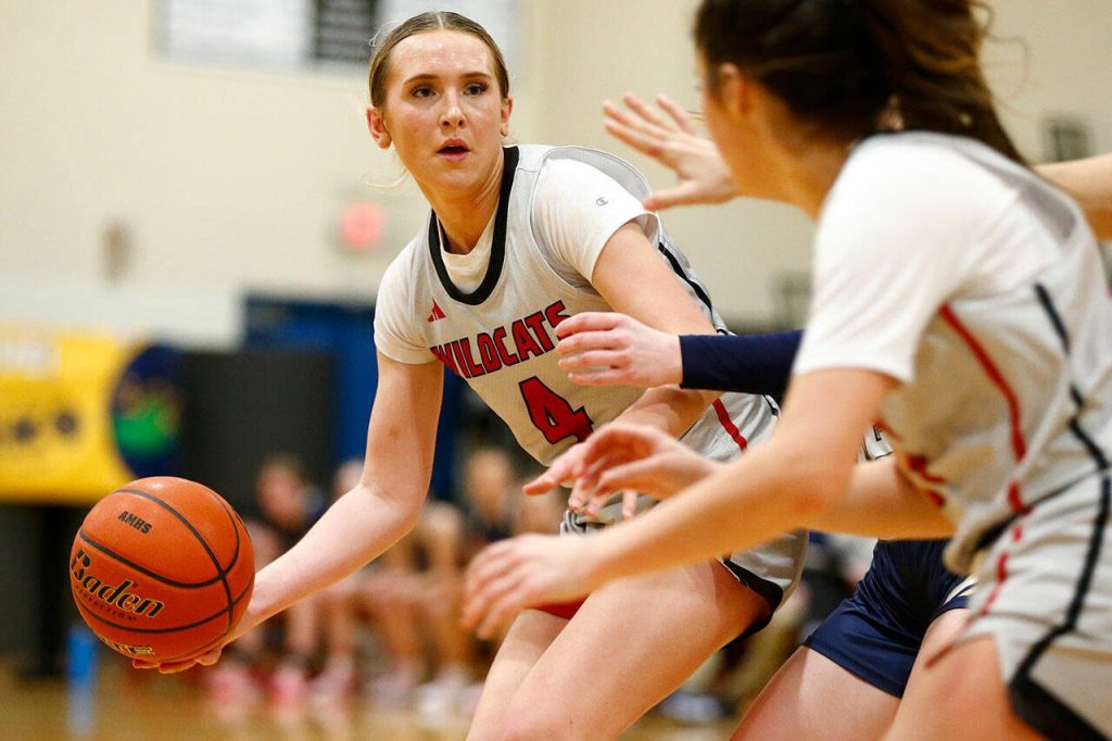 Archbishop Murphys Taylor Cushing prepares to hand off the ball against Arlington on Tuesday, Jan. 9, 2024, at Archbishop Murphy High School in Everett, Washington. (Ryan Berry / The Herald)