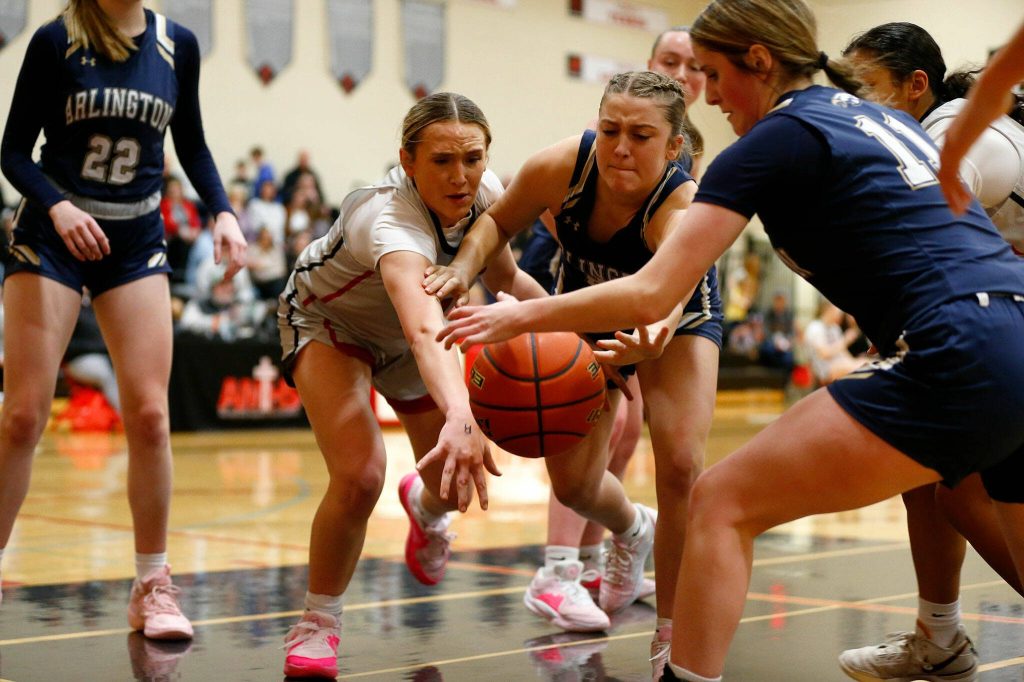 Players scramble for a rebound during a matchup between Archbishop Murphy and Arlington on Tuesday at Archbishop Murphy High School in Everett. (Ryan Berry / The Herald)