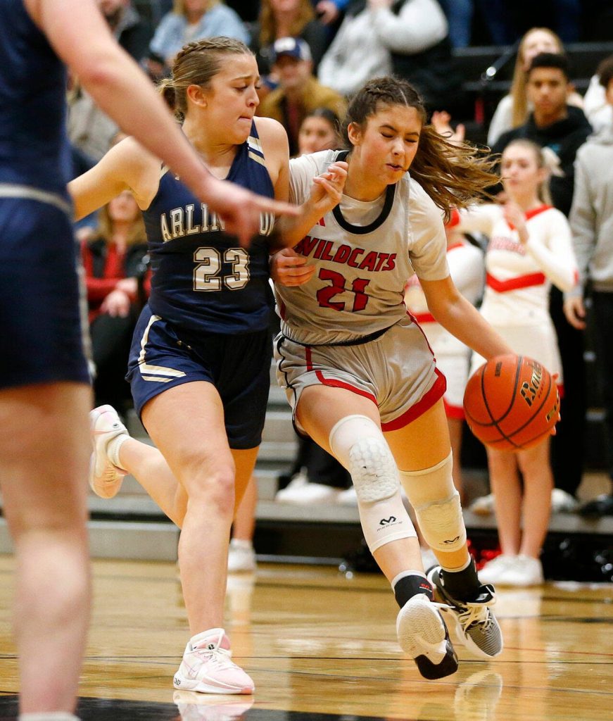 Archbishop Murphy guard Ava Marr is called for an offensive foul on Arlingtons Jersey Walker on Tuesday, Jan. 9, 2024, at Archbishop Murphy High School in Everett, Washington. (Ryan Berry / The Herald)