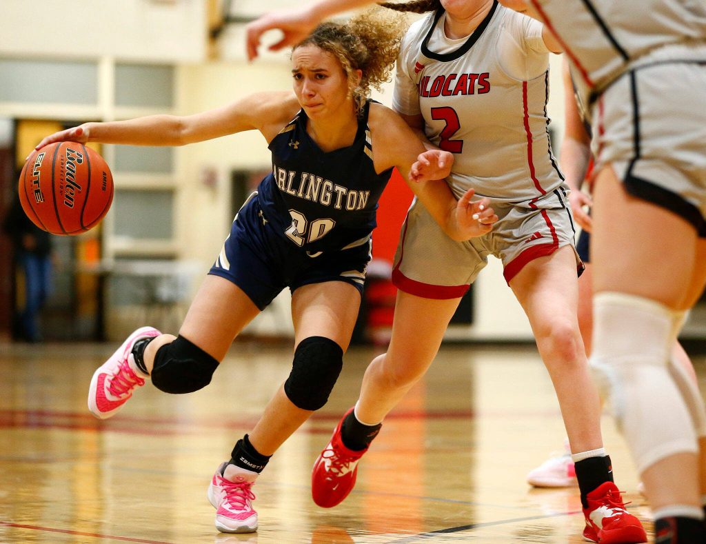 Arlington senior Samara Morrow drives on a defender against Archbishop Murphy on Tuesday at Archbishop Murphy High School in Everett. (Ryan Berry / The Herald)
