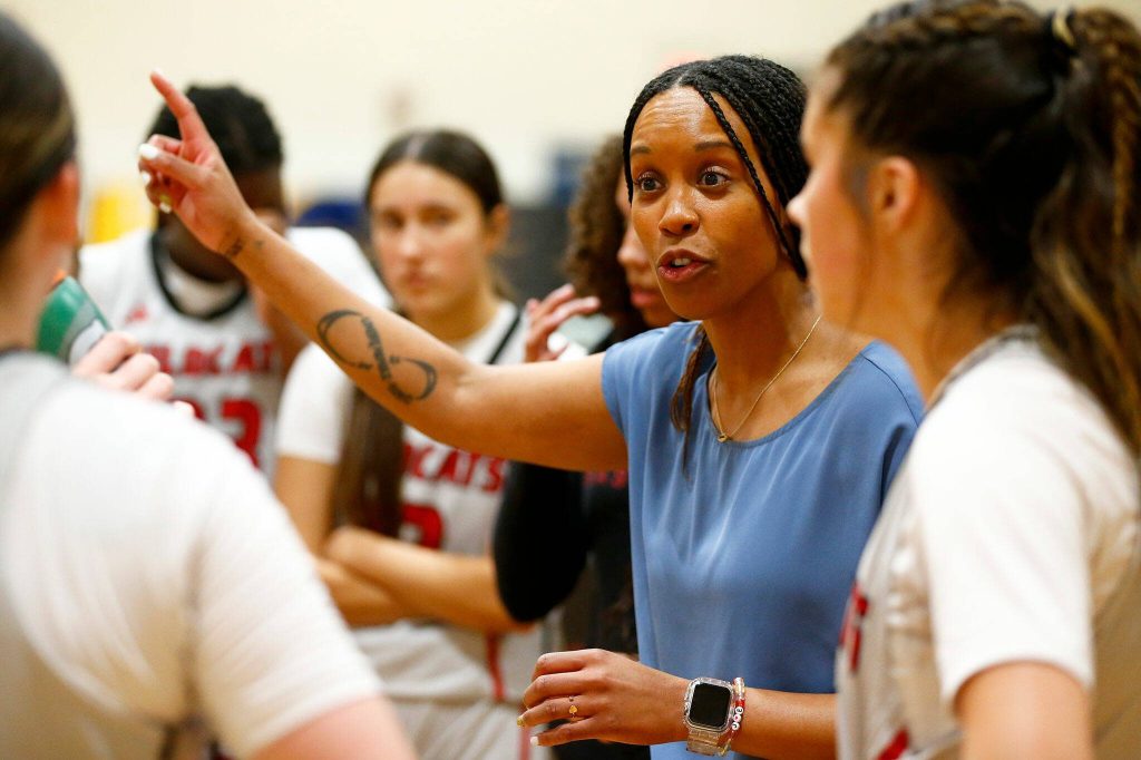Archbishop Murphy head coach Ebany Herd talks to her team between quarters during a game against Arlington on Tuesday, Jan. 9, 2024, at Archbishop Murphy High School in Everett, Washington. (Ryan Berry / The Herald)