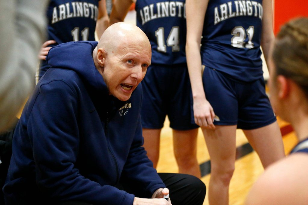 Arlington head coach Joe Marsh talks to his team at the end of the first quarter of a game against Archbishop Murphy on Tuesday, Jan. 9, 2024, at Archbishop Murphy High School in Everett, Washington. (Ryan Berry / The Herald)