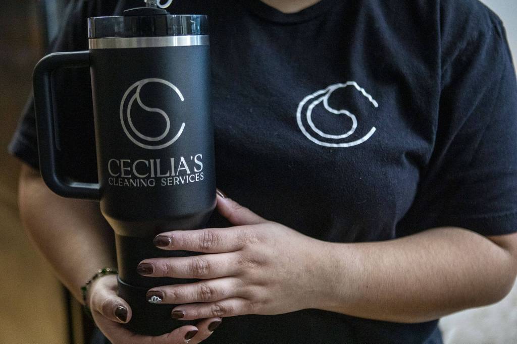 Cecilia Garcia had a custom water bottle made for her business, Cecilias Cleaning Services. (Annie Barker / The Herald)