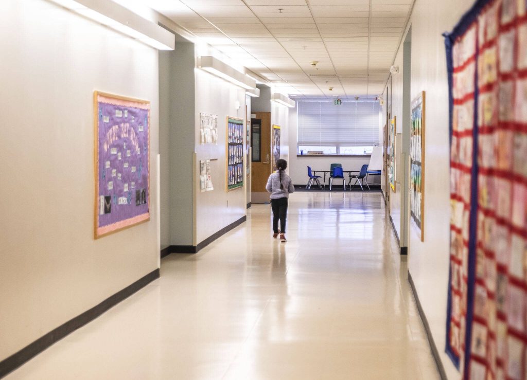 A Fairmount Elementary student walks down the southern most hallway in school on Wednesday, Jan. 10, 2024 in Everett, Washington. (Olivia Vanni / The Herald)