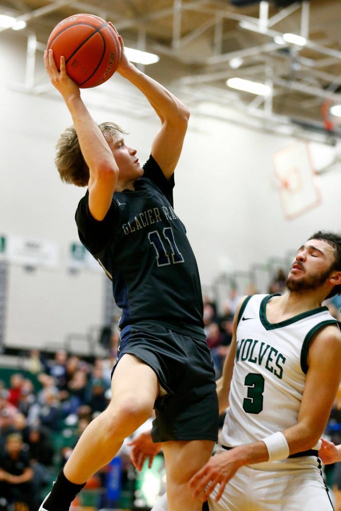 Glacier Peaks Reed Nagel tries to get a twisting shot to fall against Jackson on Wednesday at Henry M. Jackson High School in Mill Creek. (Ryan Berry / The Herald)